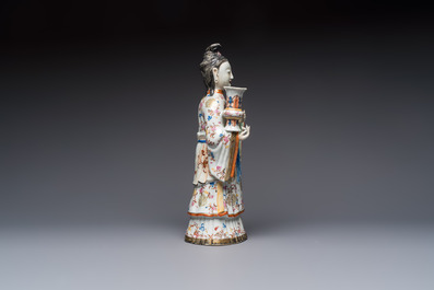 A Chinese famille rose candle holder in the shape of a court lady holding a 'Gu' vase, Qianlong