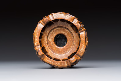 A Chinese white-glazed cup on a wooden stand, 17th C.