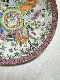 A Chinese Canton famille rose cup and saucer with figures in a garden, 19th C.