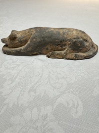 A Chinese grey pottery model of a reclining dog, Han
