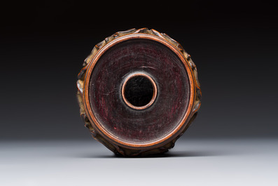 A Chinese white-glazed cup on a wooden stand, 17th C.