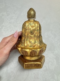 A Japanese Satsuma figure of Buddha seated on a lotus base, Hododa 保土田 mark, Meiji, 19/20th C.