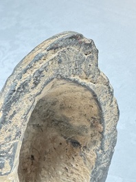 A Chinese grey pottery model of a reclining dog, Han