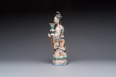 A Chinese famille rose candle holder in the shape of a court lady holding a 'Gu' vase, Qianlong