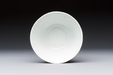 A Chinese white-glazed cup on a wooden stand, 17th C.