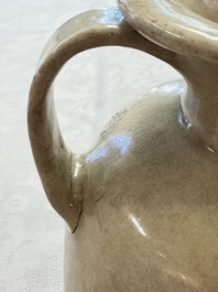 A Chinese cream-glazed ewer with a barrel-shaped body, Hebei/Henan provinces, Tang/Five Dynasties
