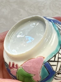 A fine Chinese famille rose cup and saucer with a couple on a terrace, Yongzheng/Qianlong