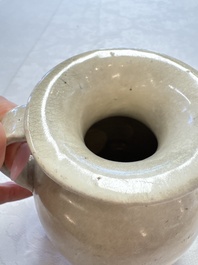 A Chinese cream-glazed ewer with a barrel-shaped body, Hebei/Henan provinces, Tang/Five Dynasties