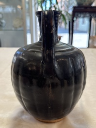 A Chinese Yaozhou black-glazed ewer with a ribbed body, Song