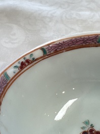A fine Chinese famille rose cup and saucer with a couple on a terrace, Yongzheng/Qianlong
