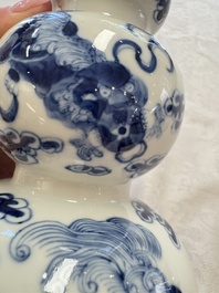 A pair of Chinese blue and white 'Buddhist Lions' triple gourd vases on reticulated wooden stands, 19th C.