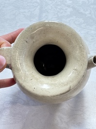 A Chinese cream-glazed ewer with a barrel-shaped body, Hebei/Henan provinces, Tang/Five Dynasties