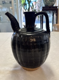 A Chinese Yaozhou black-glazed ewer with a ribbed body, Song