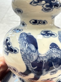 A pair of Chinese blue and white 'Buddhist Lions' triple gourd vases on reticulated wooden stands, 19th C.