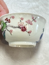 A fine Chinese famille rose cup and saucer with a couple on a terrace, Yongzheng/Qianlong