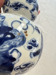A pair of Chinese blue and white 'Buddhist Lions' triple gourd vases on reticulated wooden stands, 19th C.