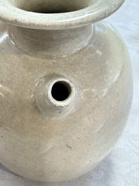 A Chinese cream-glazed ewer with a barrel-shaped body, Hebei/Henan provinces, Tang/Five Dynasties