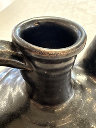 A Chinese Yaozhou black-glazed ewer with a ribbed body, Song