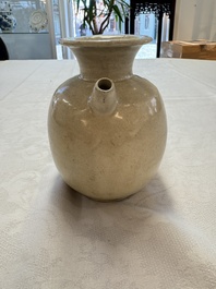A Chinese cream-glazed ewer with a barrel-shaped body, Hebei/Henan provinces, Tang/Five Dynasties