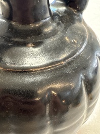 A Chinese Yaozhou black-glazed ewer with a ribbed body, Song