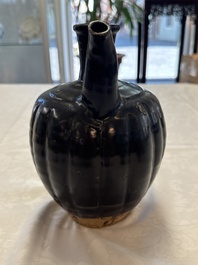 A Chinese Yaozhou black-glazed ewer with a ribbed body, Song
