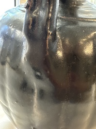 A Chinese Yaozhou black-glazed ewer with a ribbed body, Song