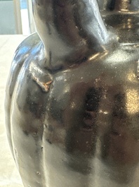 A Chinese Yaozhou black-glazed ewer with a ribbed body, Song
