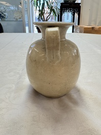 A Chinese cream-glazed ewer with a barrel-shaped body, Hebei/Henan provinces, Tang/Five Dynasties
