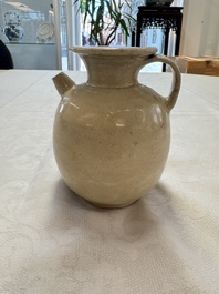 A Chinese cream-glazed ewer with a barrel-shaped body, Hebei/Henan provinces, Tang/Five Dynasties