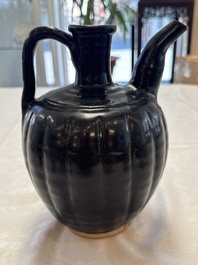 A Chinese Yaozhou black-glazed ewer with a ribbed body, Song