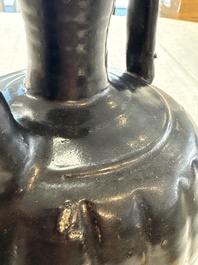 A Chinese Yaozhou black-glazed ewer with a ribbed body, Song