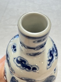 A pair of Chinese blue and white 'Buddhist Lions' triple gourd vases on reticulated wooden stands, 19th C.