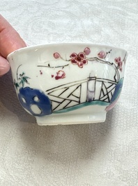 A fine Chinese famille rose cup and saucer with a couple on a terrace, Yongzheng/Qianlong