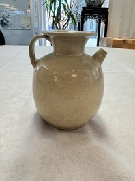 A Chinese cream-glazed ewer with a barrel-shaped body, Hebei/Henan provinces, Tang/Five Dynasties