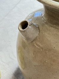 A Chinese cream-glazed ewer with a barrel-shaped body, Hebei/Henan provinces, Tang/Five Dynasties