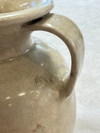 A Chinese cream-glazed ewer with a barrel-shaped body, Hebei/Henan provinces, Tang/Five Dynasties