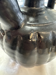 A Chinese Yaozhou black-glazed ewer with a ribbed body, Song