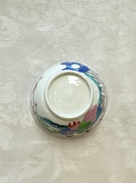 A fine Chinese famille rose cup and saucer with a couple on a terrace, Yongzheng/Qianlong