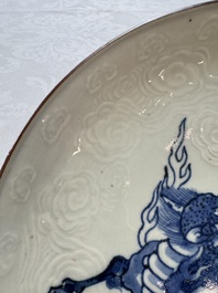 A Japanese Arita blue and white Kakiemon-style 'Kirin' plate with underglaze relief design, Edo, 18th C.