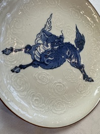 A Japanese Arita blue and white Kakiemon-style 'Kirin' plate with underglaze relief design, Edo, 18th C.