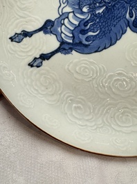A Japanese Arita blue and white Kakiemon-style 'Kirin' plate with underglaze relief design, Edo, 18th C.