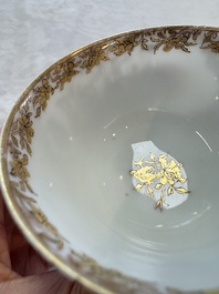 A fine Chinese Canton famille rose gilt-decorated cup and saucer with figural design, Yongzheng/Qianlong