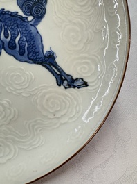 A Japanese Arita blue and white Kakiemon-style 'Kirin' plate with underglaze relief design, Edo, 18th C.