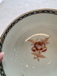 A Chinese famille verte relief-carved bowl with gilt iron-red floral design, Kangxi