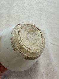 A Chinese white-glazed cup on a wooden stand, 17th C.