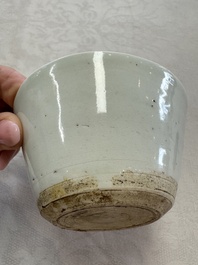 A Chinese white-glazed cup on a wooden stand, 17th C.