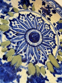 A Persian blue, white, and green glazed dish with stylised floral design, Safavid, 17/18th C.