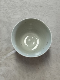 A Chinese white-glazed cup on a wooden stand, 17th C.