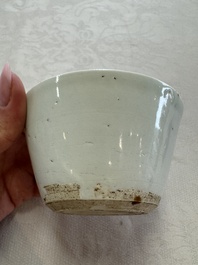 A Chinese white-glazed cup on a wooden stand, 17th C.
