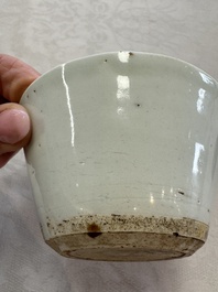 A Chinese white-glazed cup on a wooden stand, 17th C.